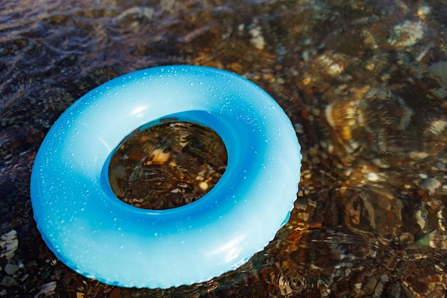 A blue rubber ring floats in the adriatic sea