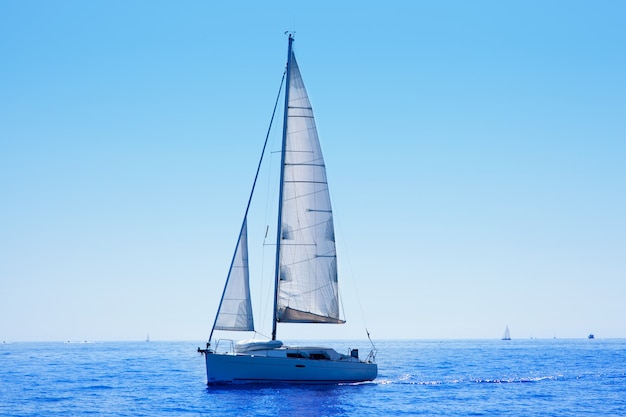 blue sailboat sailing mediterranean sea