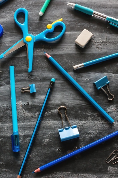 Blue school supplies on a blackboard