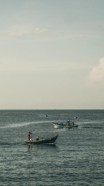 Blue Sea sky cumulus cloud landscape view background Calm water alone fishing boat Destination aim progress concept