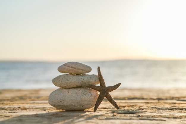 Blue Sea on surface Selective focus zen stones on sea beach meditation spa harmony calm balance concept