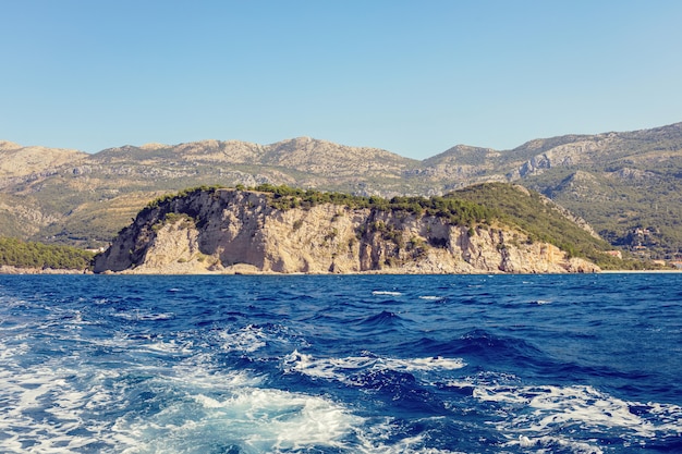 Blue sea surface with splashing waves, view from ship