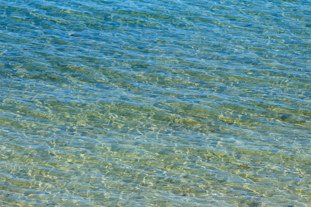 Blue sea wave with golden light reflection