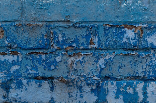 Struttura del fondo del muro di mattoni rotto squallido blu