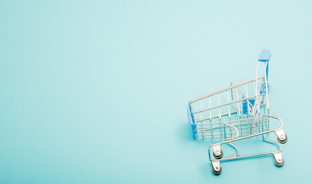 Blue shopping trolley on blue