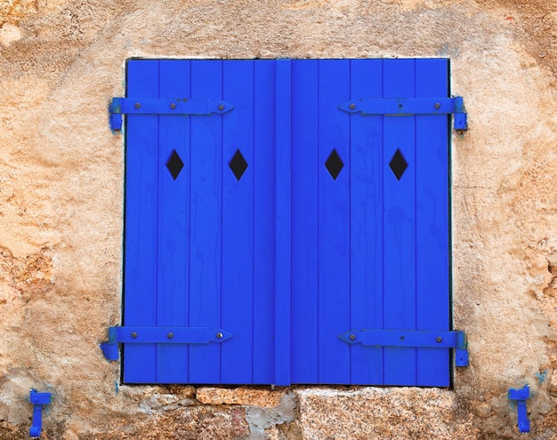 Blue shutters in an old wall