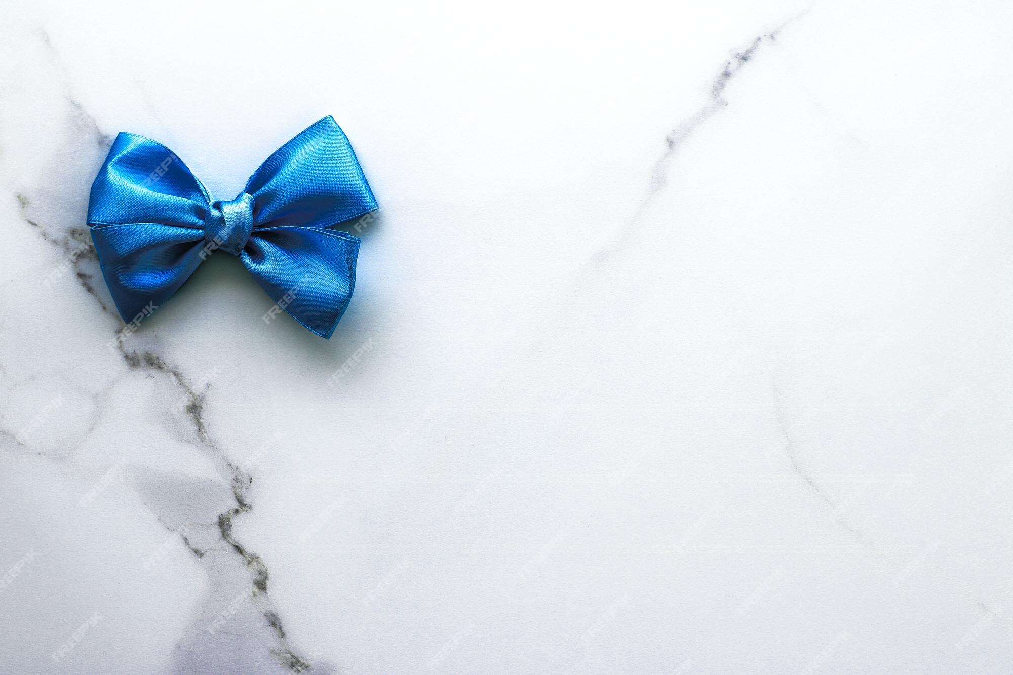 Premium Photo  Black silk ribbon and bow on marble background flatlay