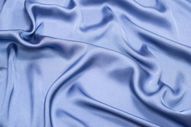 Struttura del tessuto di lusso in seta o raso blu. vista dall'alto.