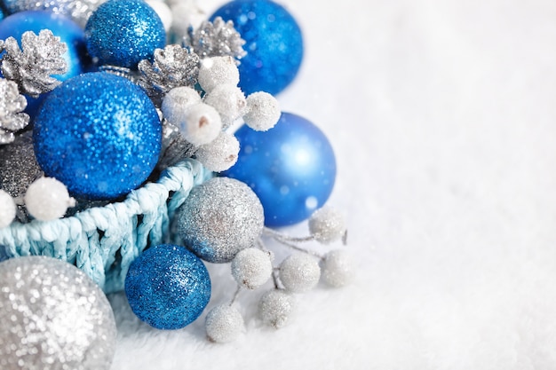 Blue and silver Christmas toys on a light background.