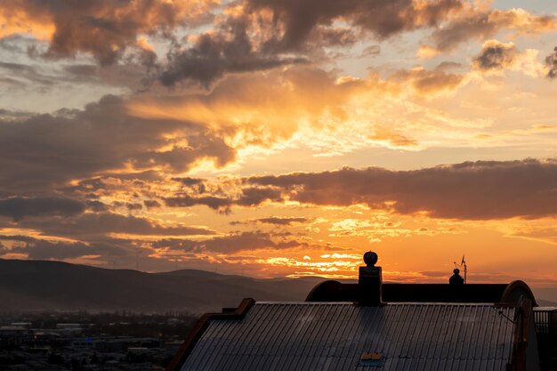 blue sky background with clouds. Beautiful sunset sky above clouds with dramatic light. Fluffy cloud