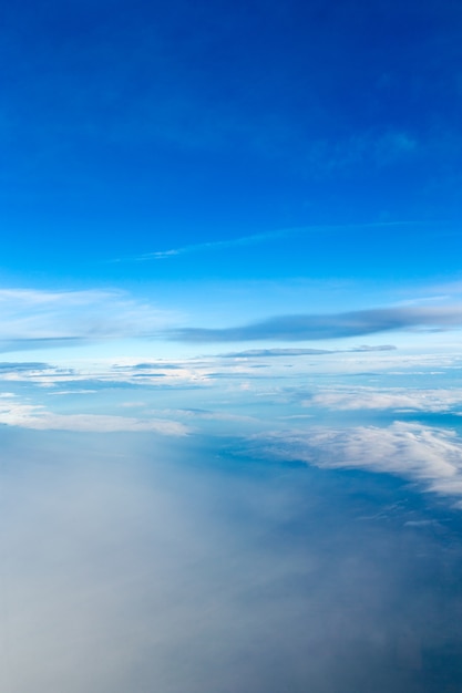 Blue sky background with tiny clouds