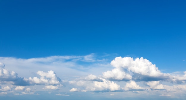 Blue sky background with tiny clouds