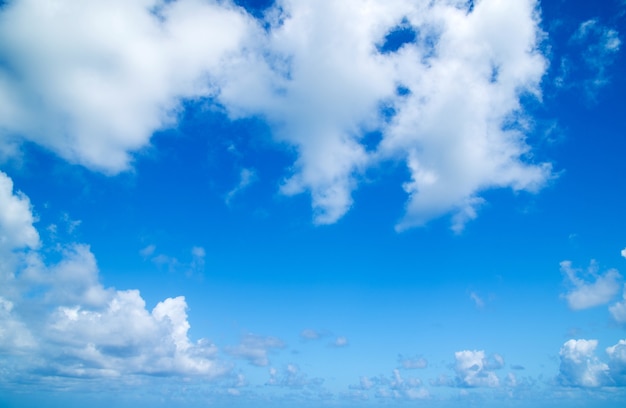 Blue sky background with tiny clouds