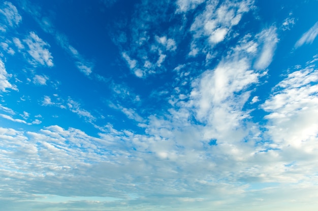 Blue sky background with tiny clouds