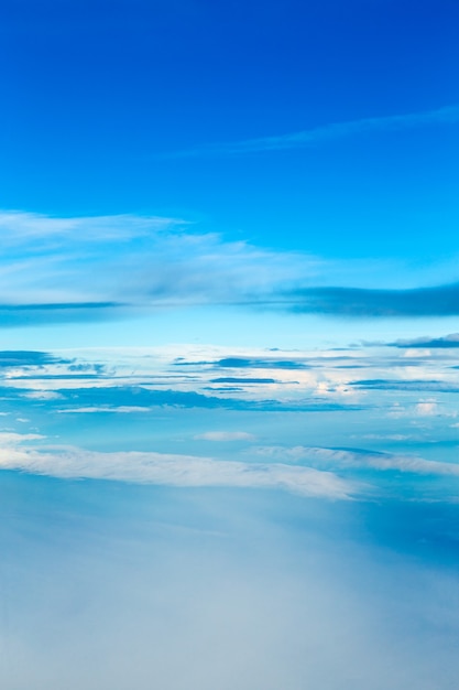 Blue sky background with tiny clouds