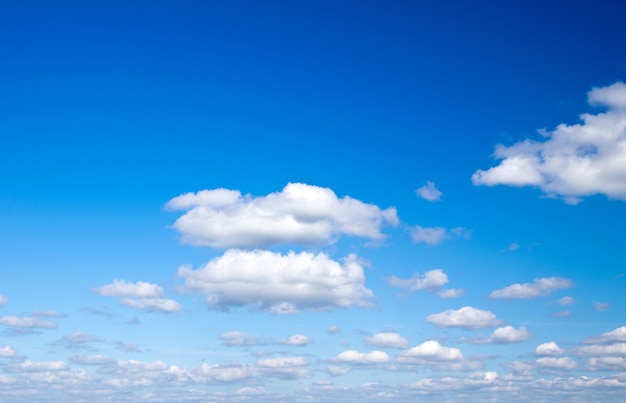 Blue sky background with tiny clouds