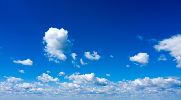 Blue sky background with tiny clouds