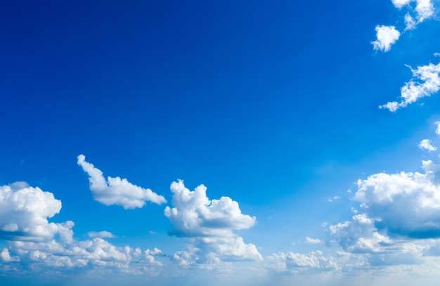 Blue sky background with tiny clouds