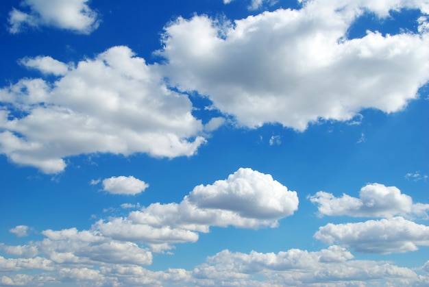 Blue sky background with tiny clouds