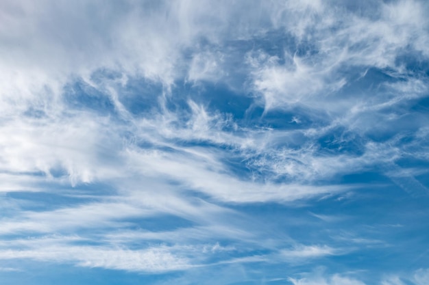 Blue sky background with tiny stratus cirrus striped clouds Clearing day and Good windy weather