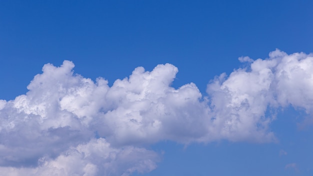 Blue sky background with white clouds on sunny day