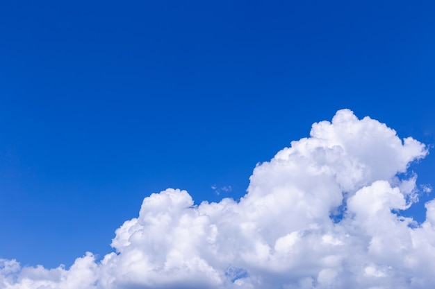 Blue sky background with white clouds on sunny day.