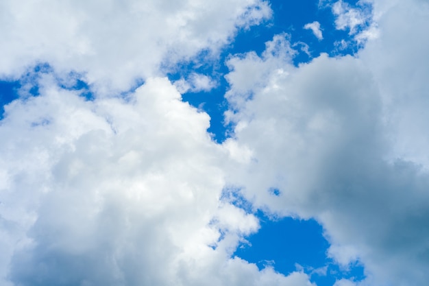 Blue sky background with white fluffy clouds - image