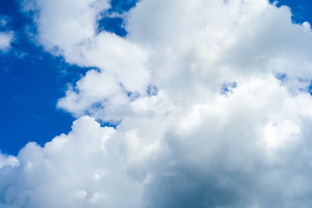 Blue sky background with white fluffy clouds - image