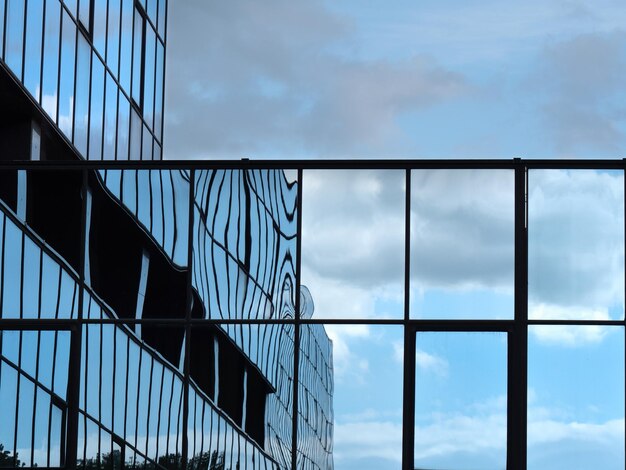 Blue sky and clouds reflected in the glass building