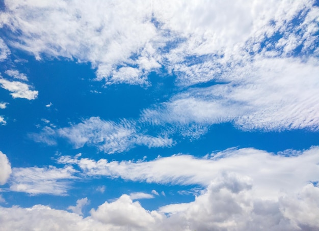 Blue sky and many white big clouds in daylight Natural sky composition Ideal for use in the design or wallpaper