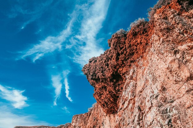 Blue sky over the rocky cliff photo