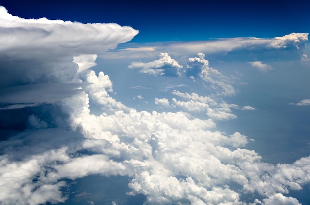 Blue sky and silky white clouds with stunning shapes and colorful views over the clouds.