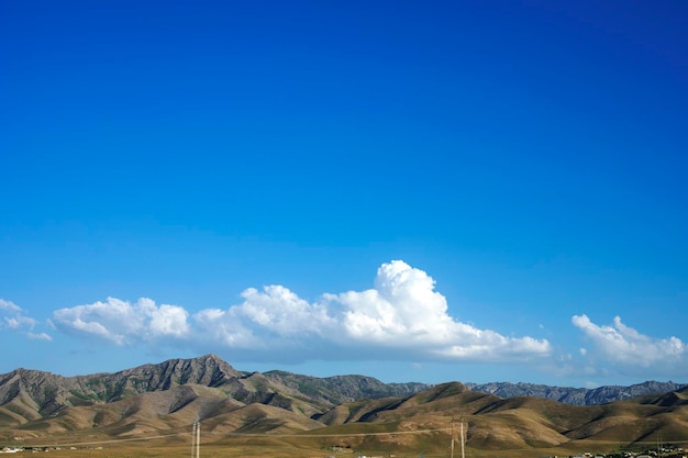 Blue sky and thick clouds over the steppe