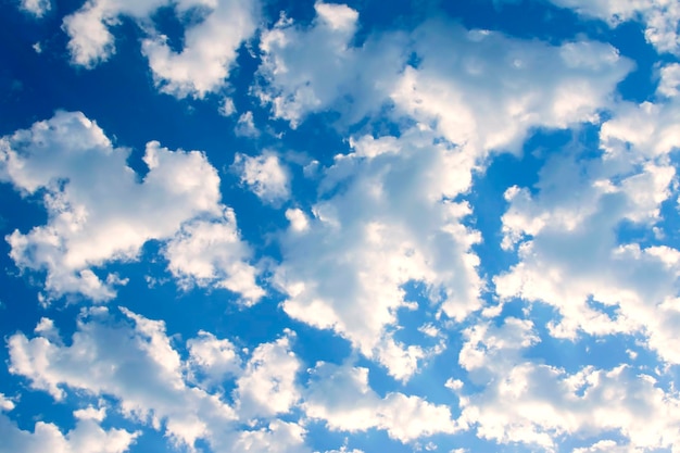 Blue sky and white clouds with pink sunlight