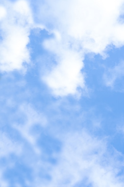 Blue sky and white fluffy cloud on a sunny day. Vertical