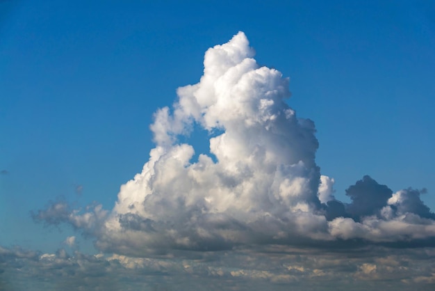 Blue sky with a big white cloud and a star inside the shape