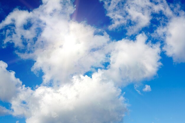 Blue sky with clouds and bright sunlight. High quality photo