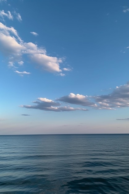 A blue sky with clouds over the water