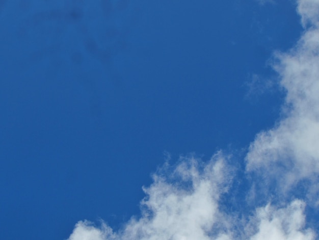 A blue sky with clouds and a white cloud