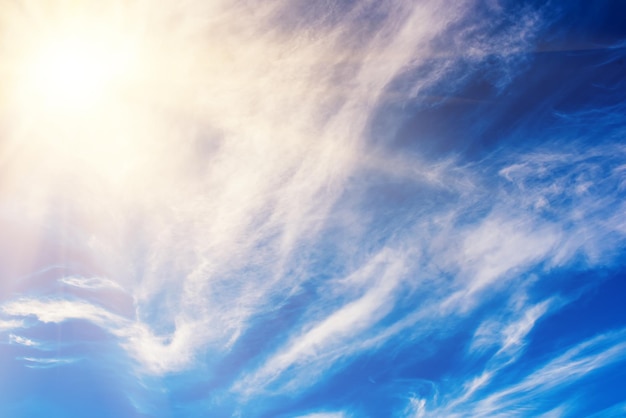 Blue sky with the fluffy white clouds vivid natural background with copy space