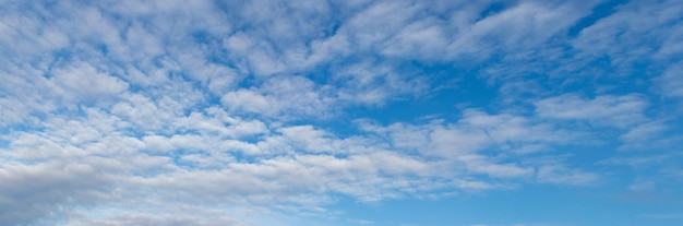 Blue sky with small white cumulus clouds copy space