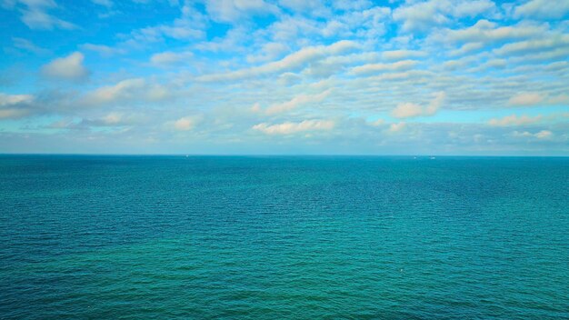 青い空と白い雲の上に 青い緑の水 ミシガン湖の空の夢のインスピレーション