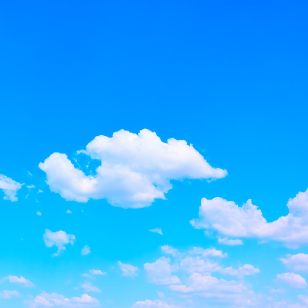 Blue sky with white clouds, may be used as background. Square cropping, space for your own text