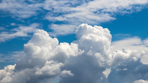 Blue sky with white curly clouds in sunny weather