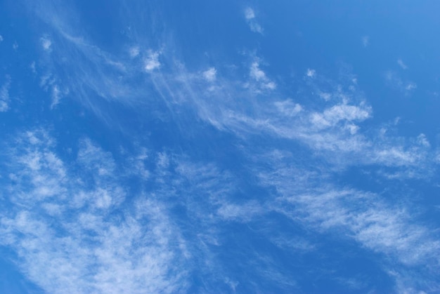 A blue sky with wispy clouds