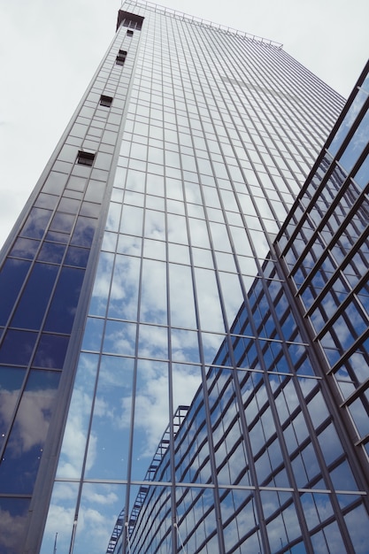 Blue skyscraper business building with glass facade bottom view