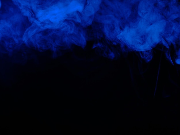 Premium Photo | Blue smoke on black background