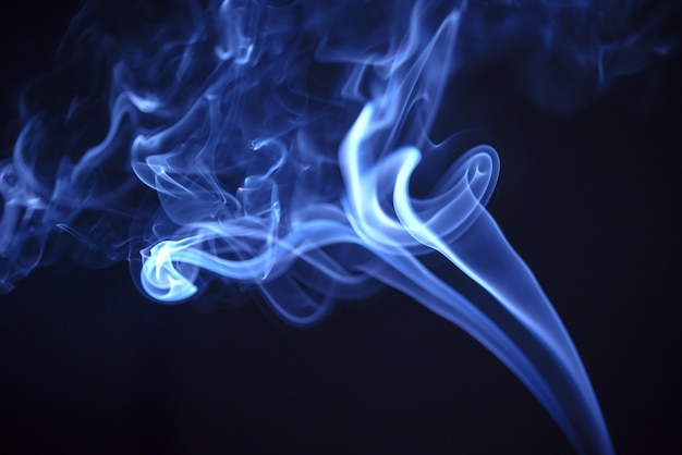 Blue smoke on black background