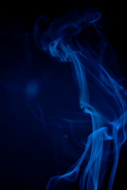 Blue smoke on black background.