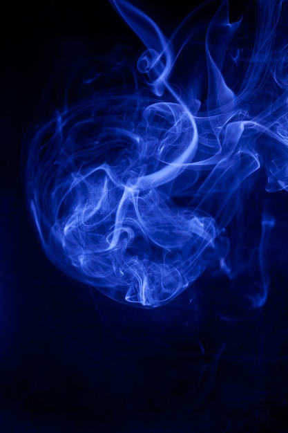 Blue smoke on a black background.